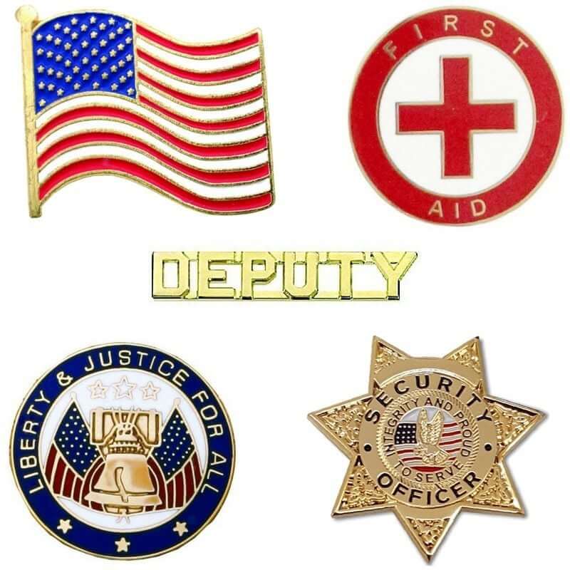 Collection of pins featuring a flag, first aid symbol, deputy badge, liberty emblem, and security officer star.