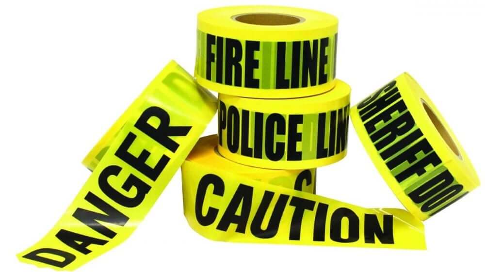 Bright yellow barrier tape rolls with messages like DANGER, CAUTION, FIRE LINE, and POLICE LINE for safety management.