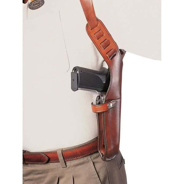 Leather concealment holster worn underarm with a firearm, showcasing comfort and accessibility for everyday carry.