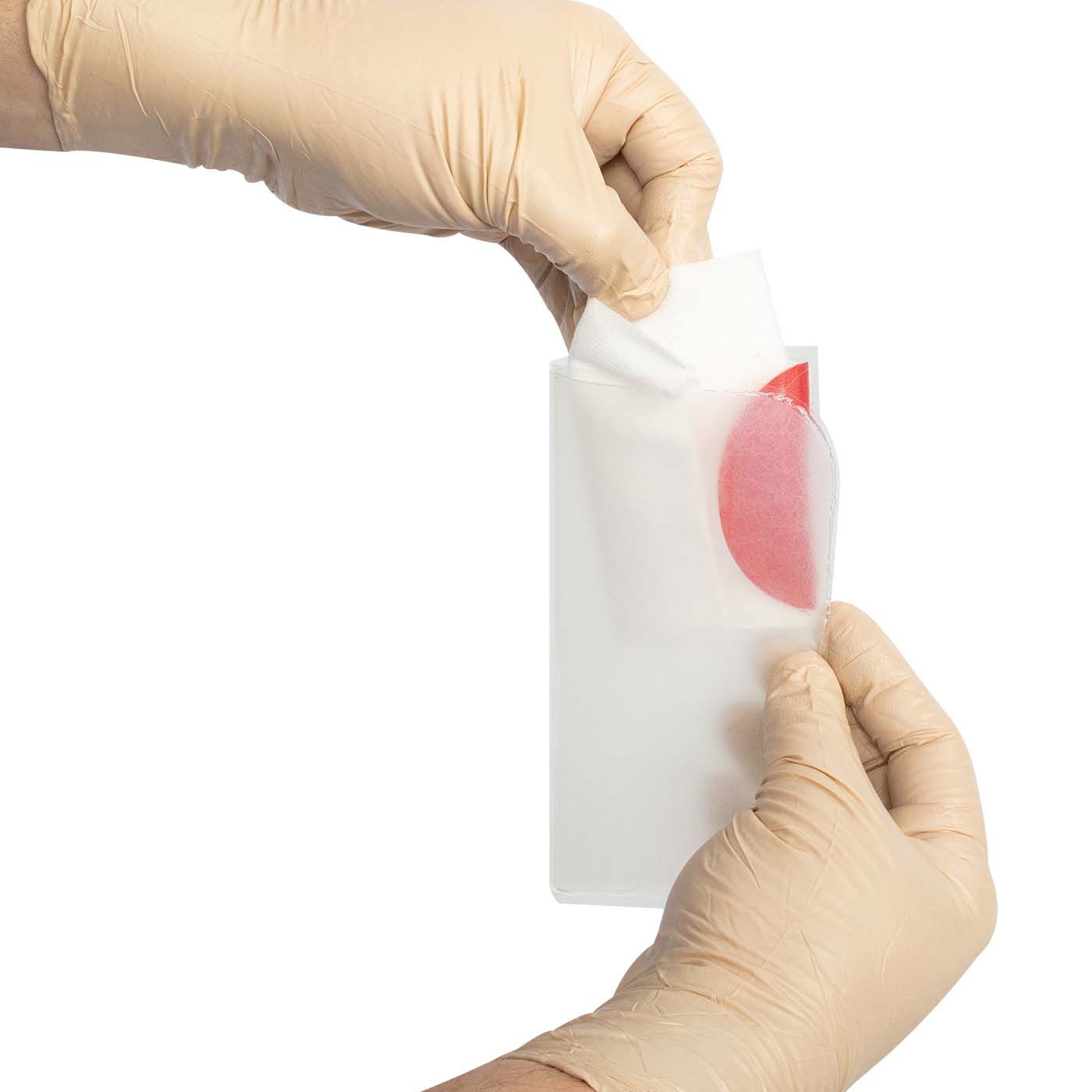 Person wearing gloves holding a white container with a red substance on a white background