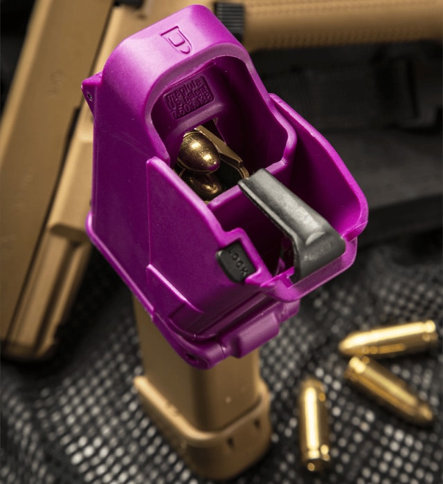 Purple firearm magazine loader with bullets on a textured surface
