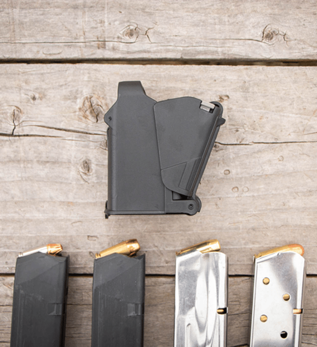 Set of gun magazines on a wooden surface