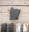 Set of gun magazines on a wooden surface