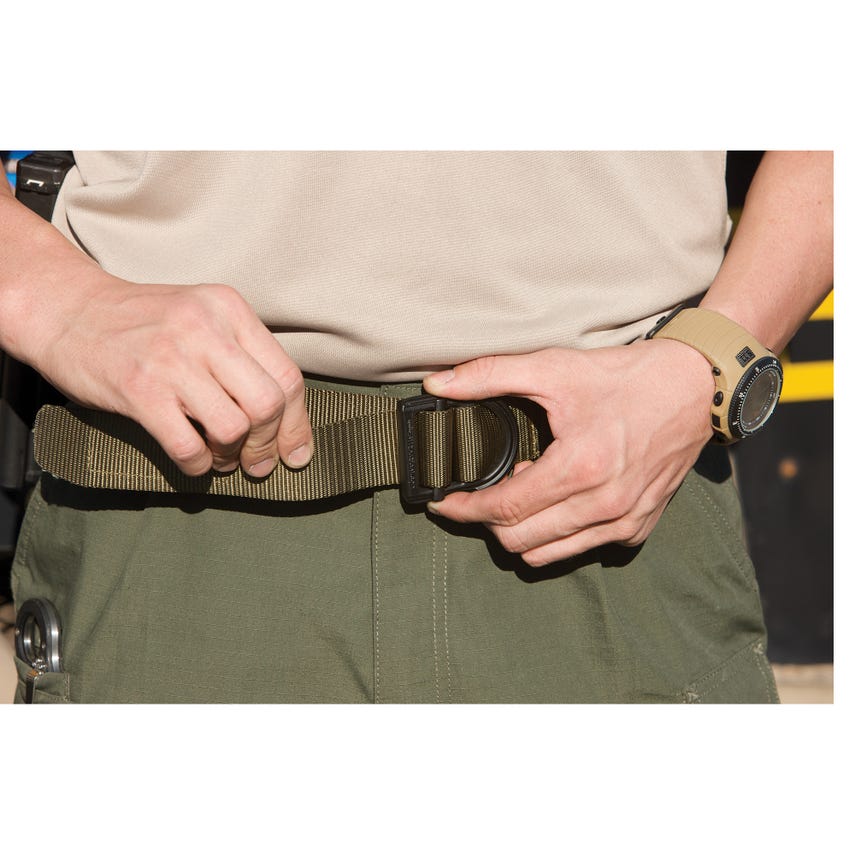 Person wearing a belt with a black buckle, holding it with both hands.