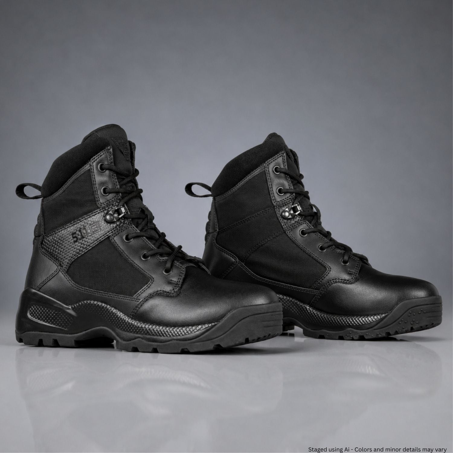 Pair of black tactical boots on a gray background