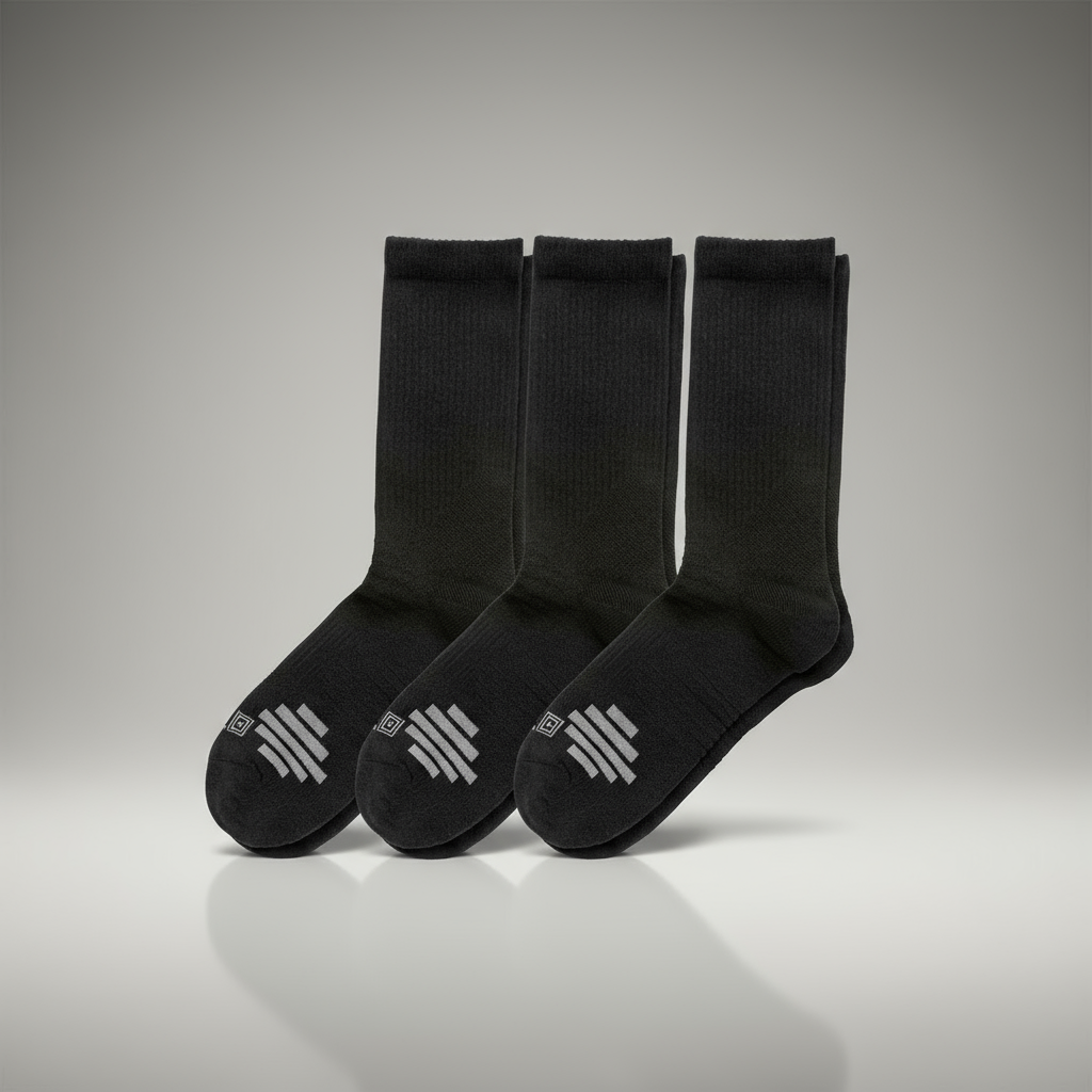Three black socks with a logo on the sole against a gray background
