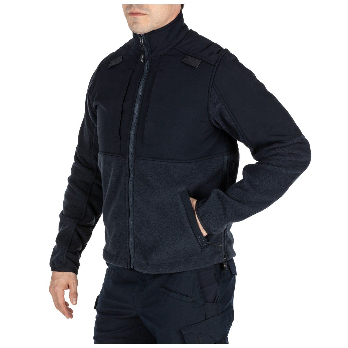 Person wearing a black tactical jacket on a white background