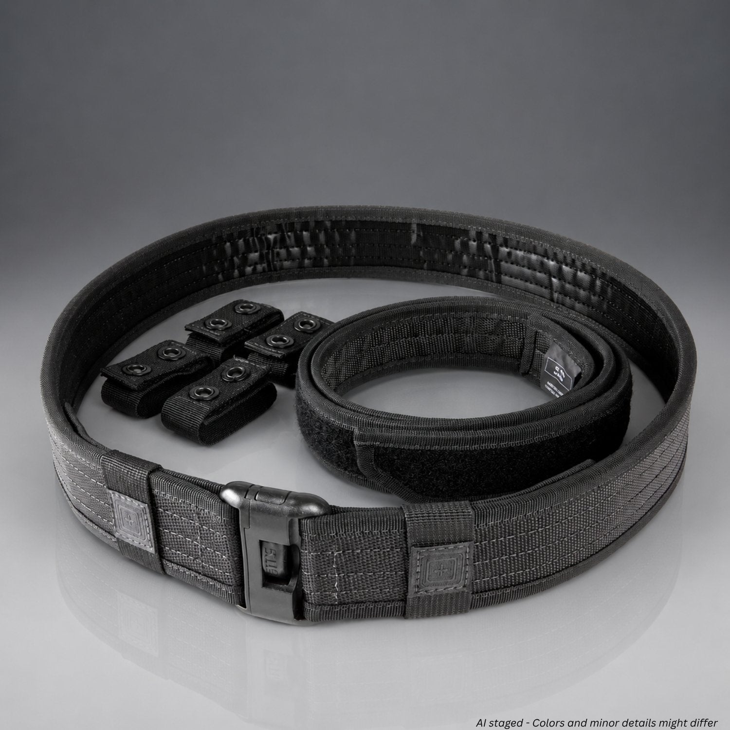 Black tactical belt with multiple buckles on a gray background