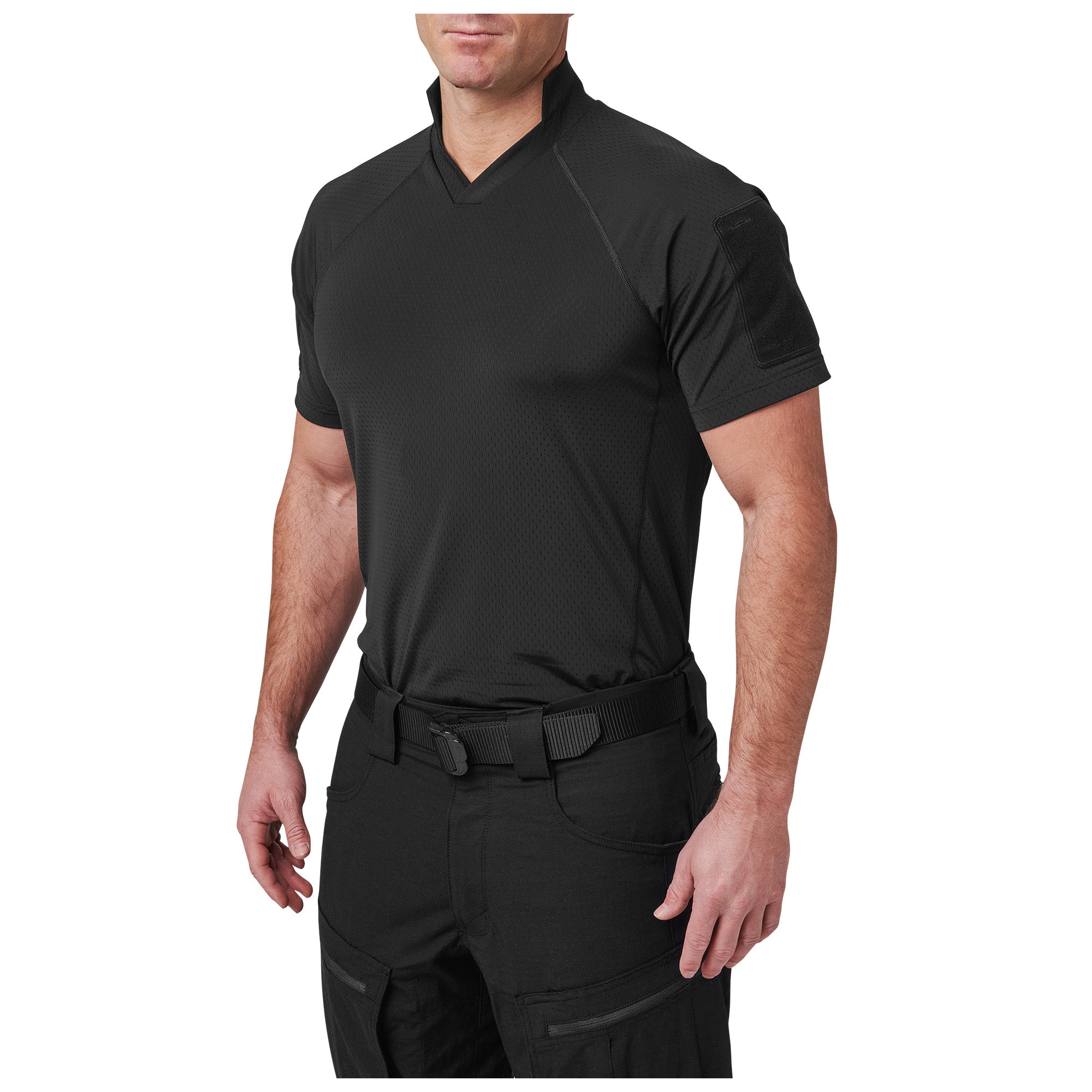 Person wearing a black tactical shirt and pants on a white background