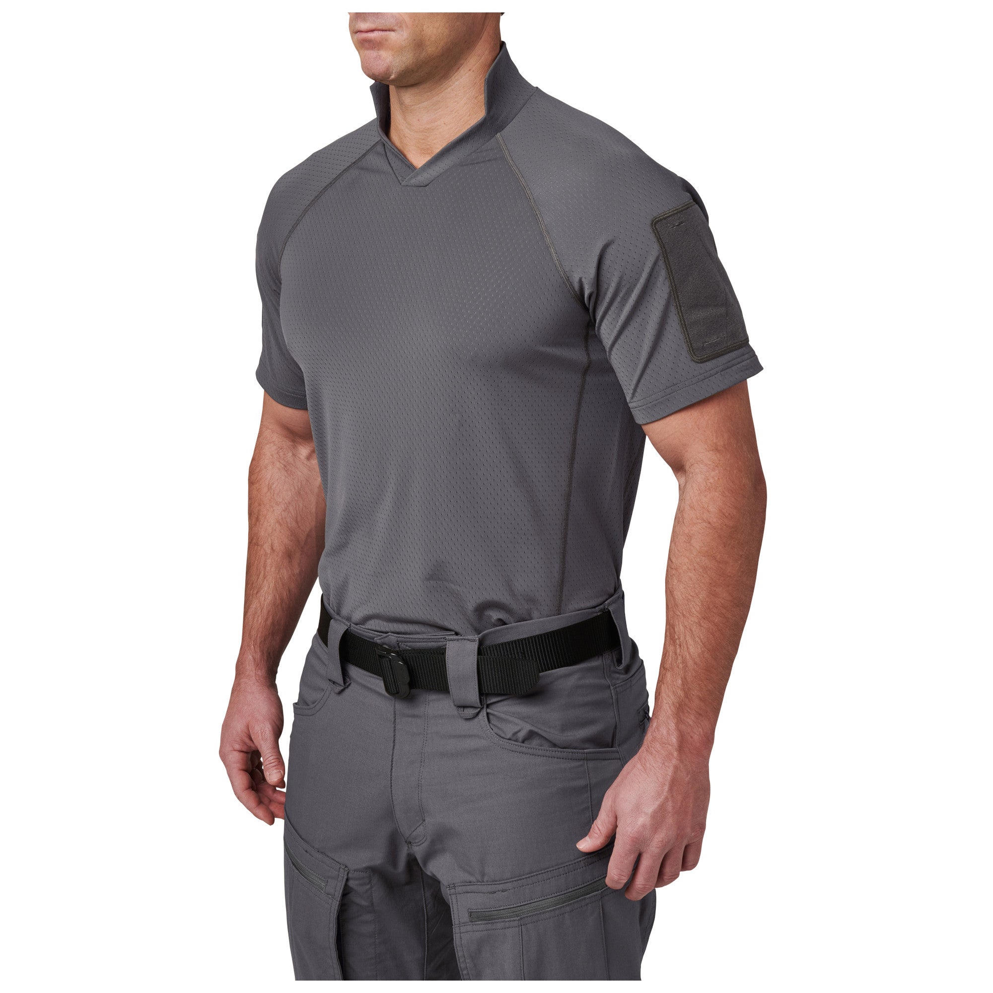 Person wearing a gray tactical shirt and pants on a white background