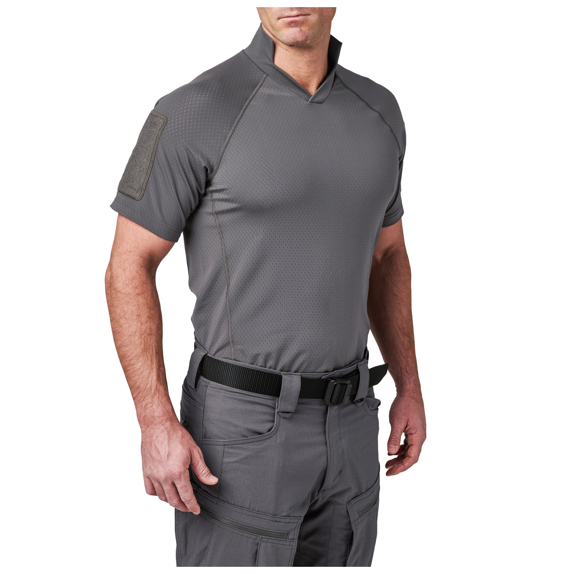 Man wearing a gray tactical shirt and pants on a white background