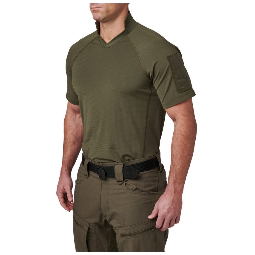 Person wearing an olive green tactical shirt and pants on a white background