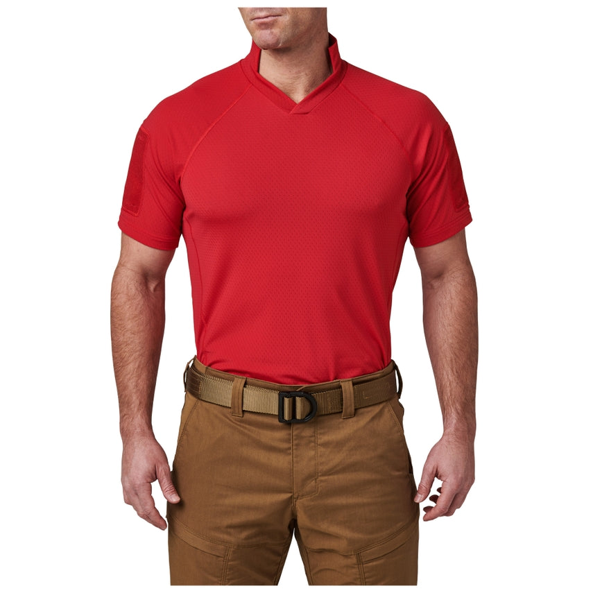 Person wearing a red shirt and brown pants on a white background