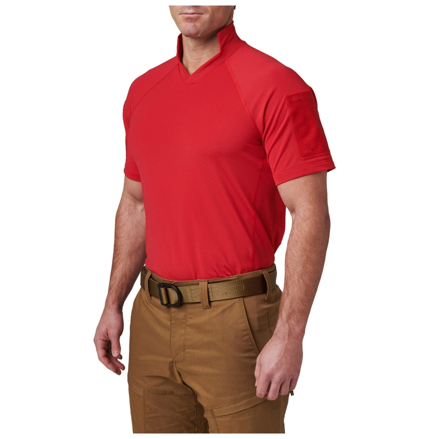 Person wearing a red shirt and brown pants on a white background