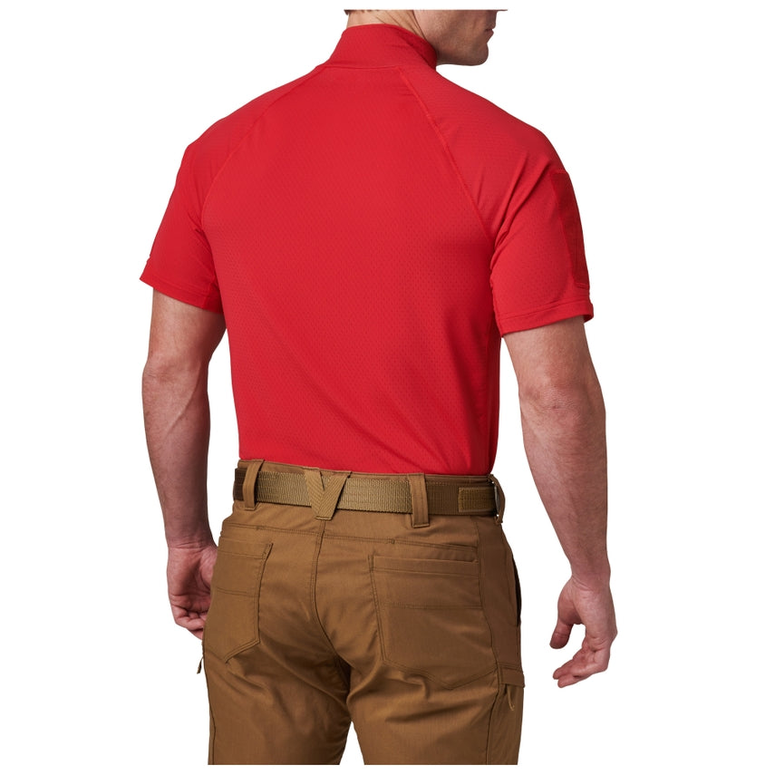 Person wearing a red shirt and brown pants on a white background
