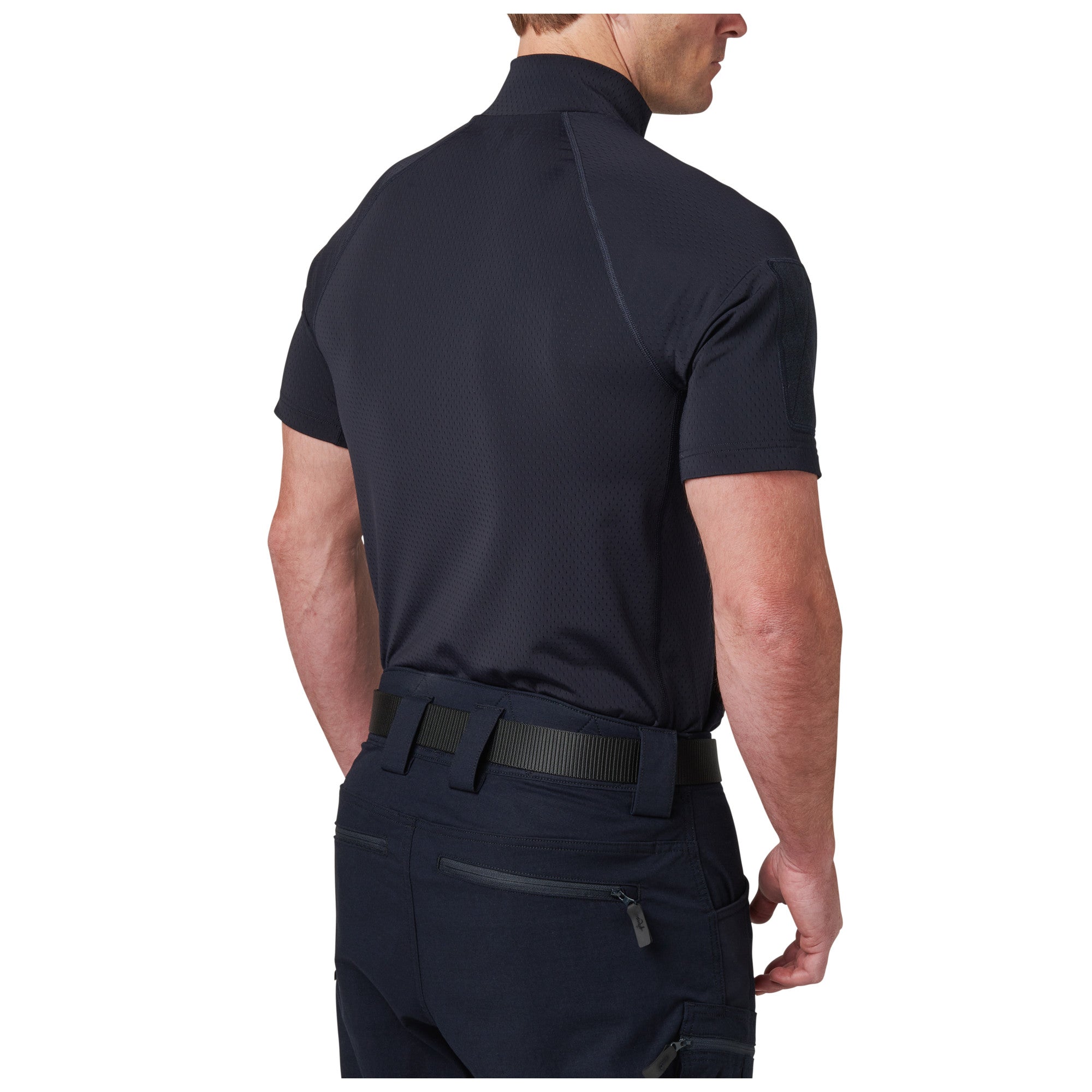 Person wearing a navy tactical shirt and pants on a white background