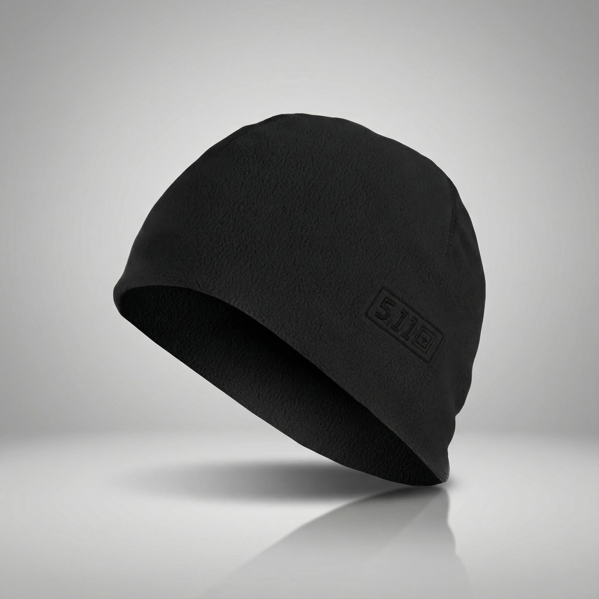 Black beanie with a brand logo on a gray background