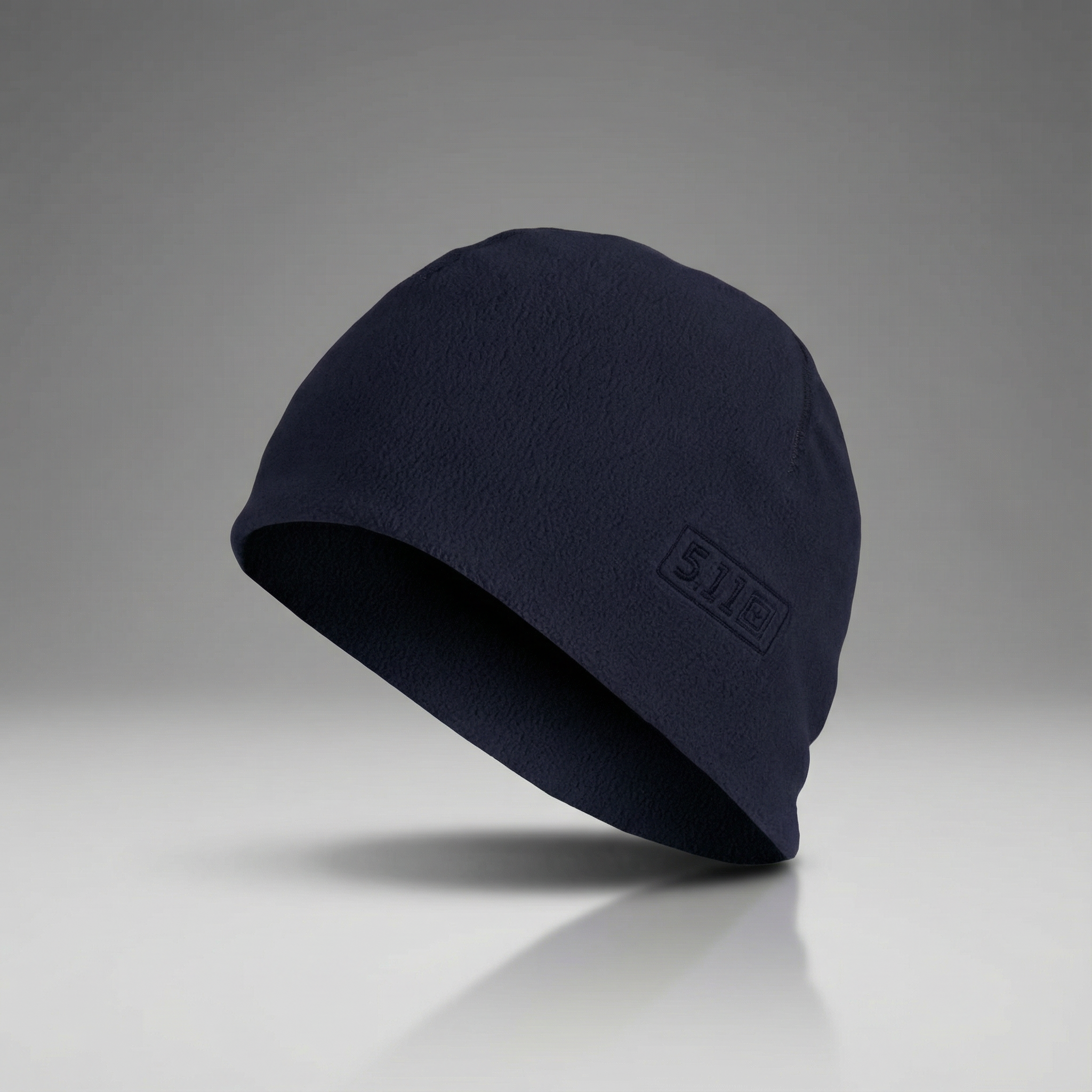 Navy blue beanie with a logo on a gray background