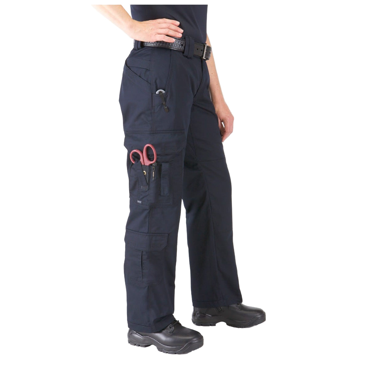 Person wearing navy blue work pants with a pocket featuring red scissors on a white background. 5.11 Tactical Women’s EMS Cargo Pants 64301 with cargo pockets