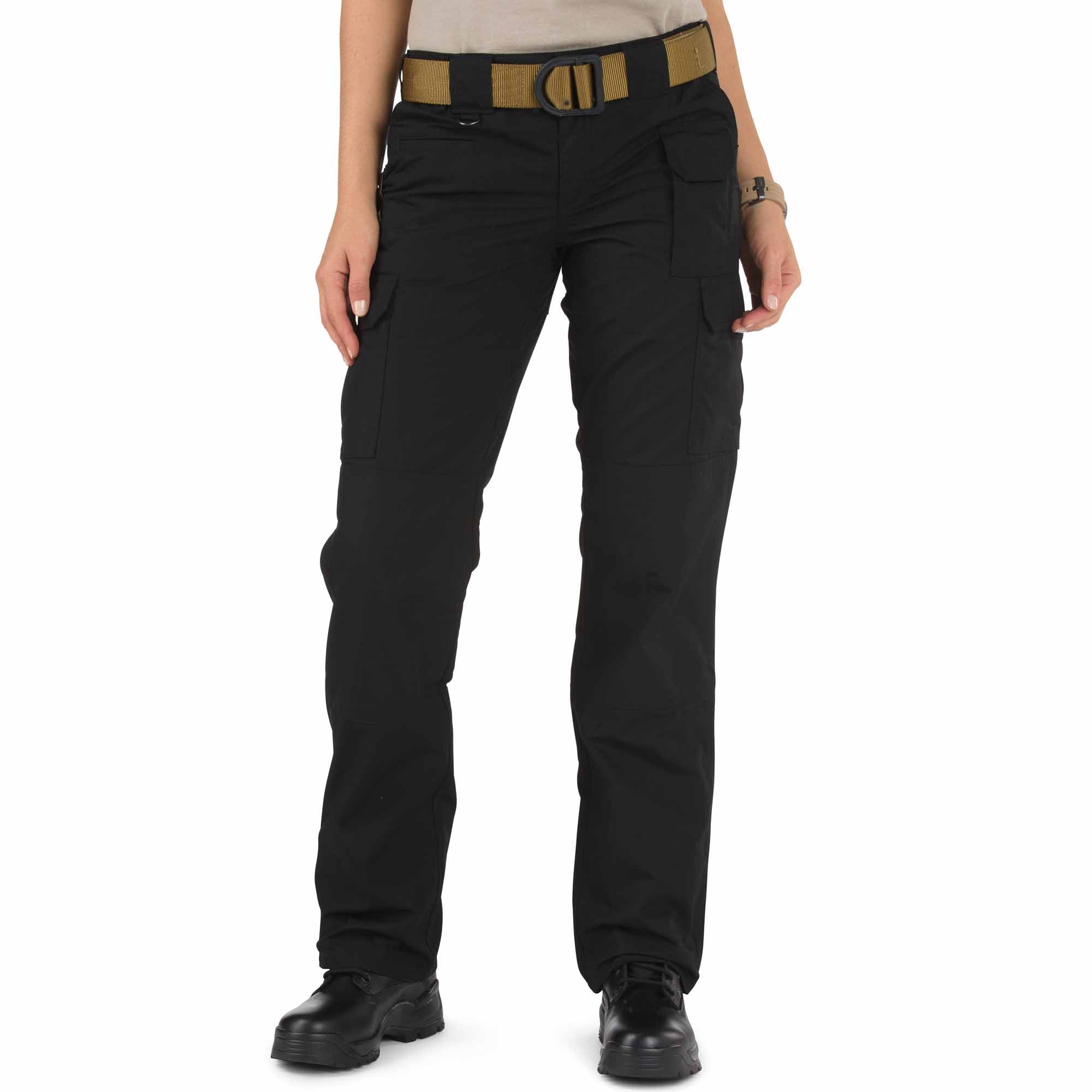 Person wearing black tactical pants with a belt on a white background