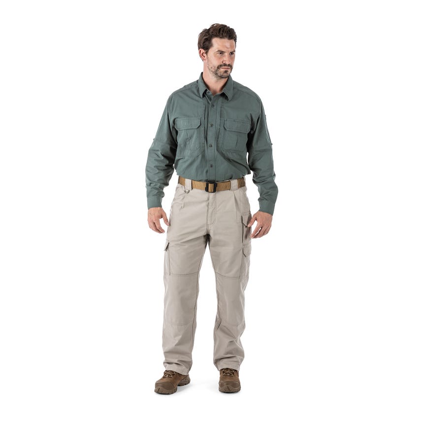Man wearing 5.11 Tactical 100% cotton canvas tactical pants and a button-up shirt, showcasing durability and functionality.