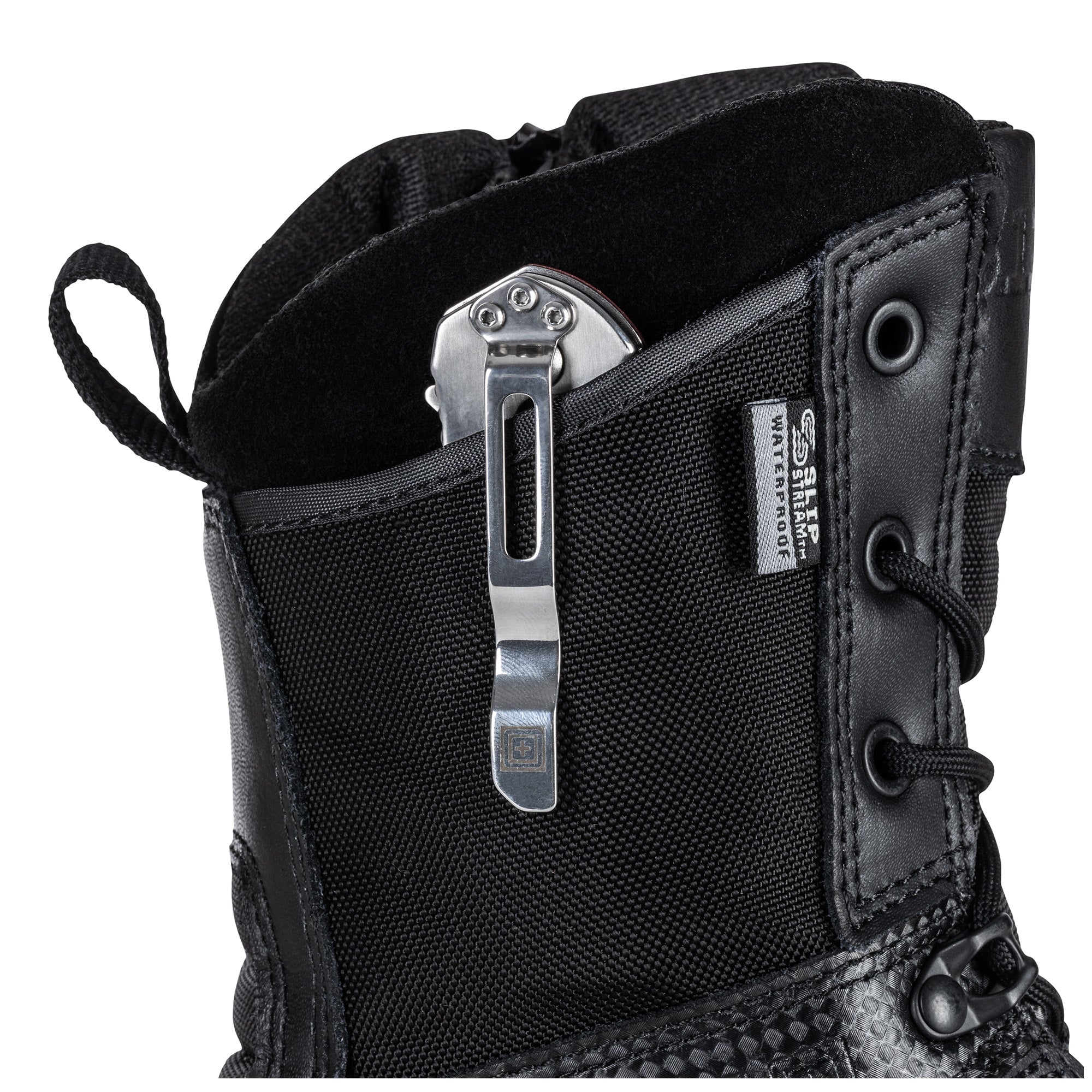 Close-up of a black boot with a metal clip on a white background