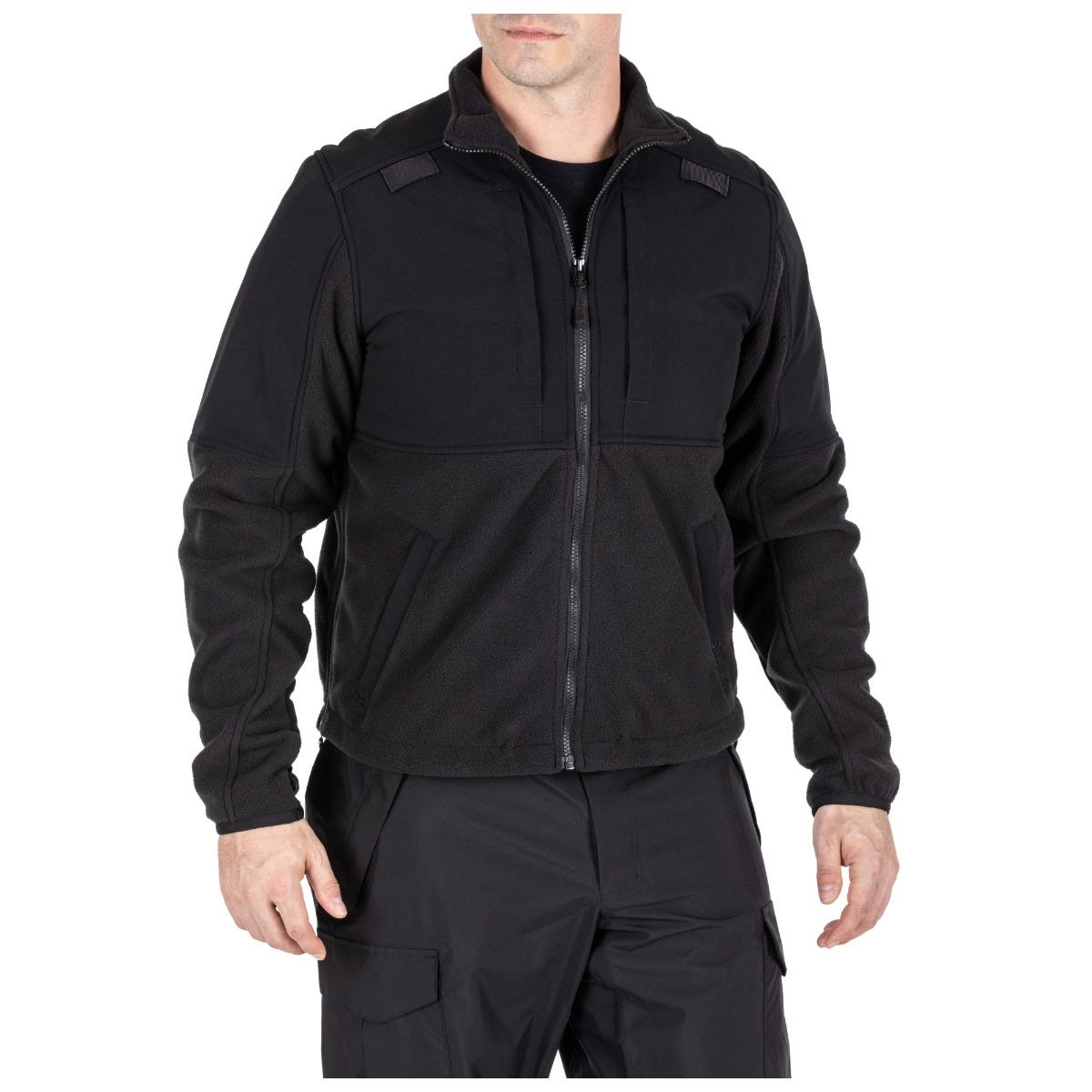 Black tactical jacket worn by a person on a white background