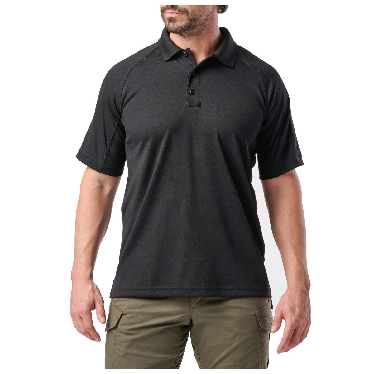 Man wearing a black polo shirt and green pants on a white background