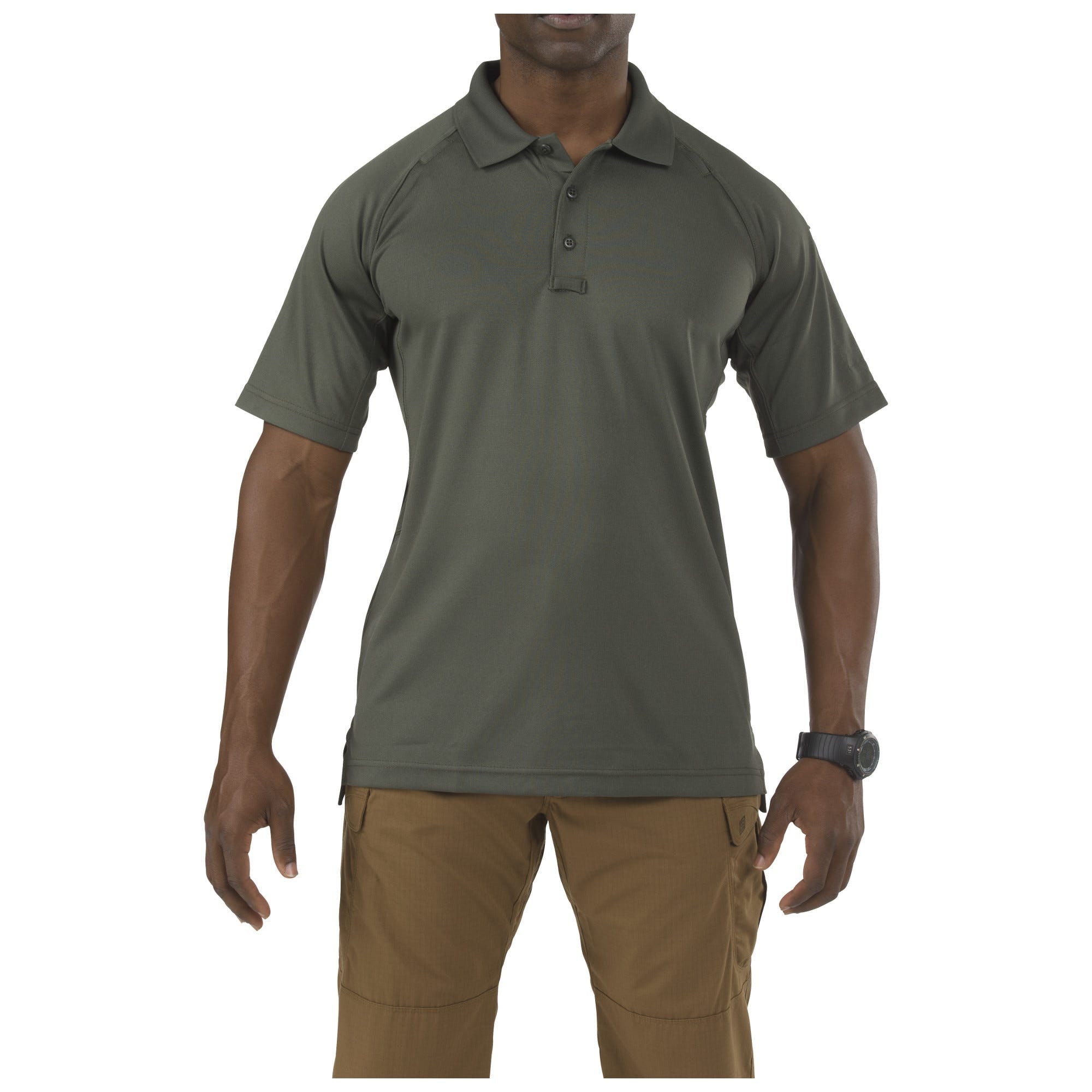 Person wearing a green polo shirt and brown pants on a white background