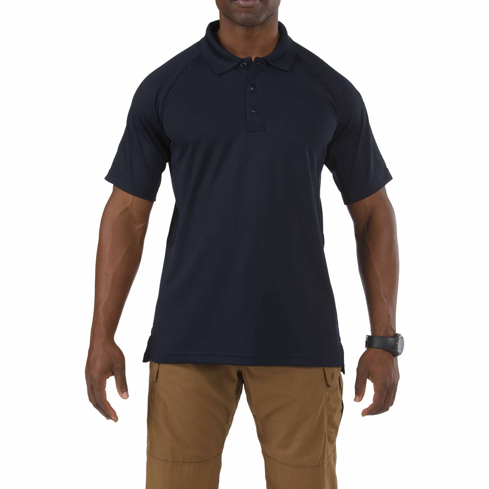 Man wearing a navy polo shirt and brown pants on a white background