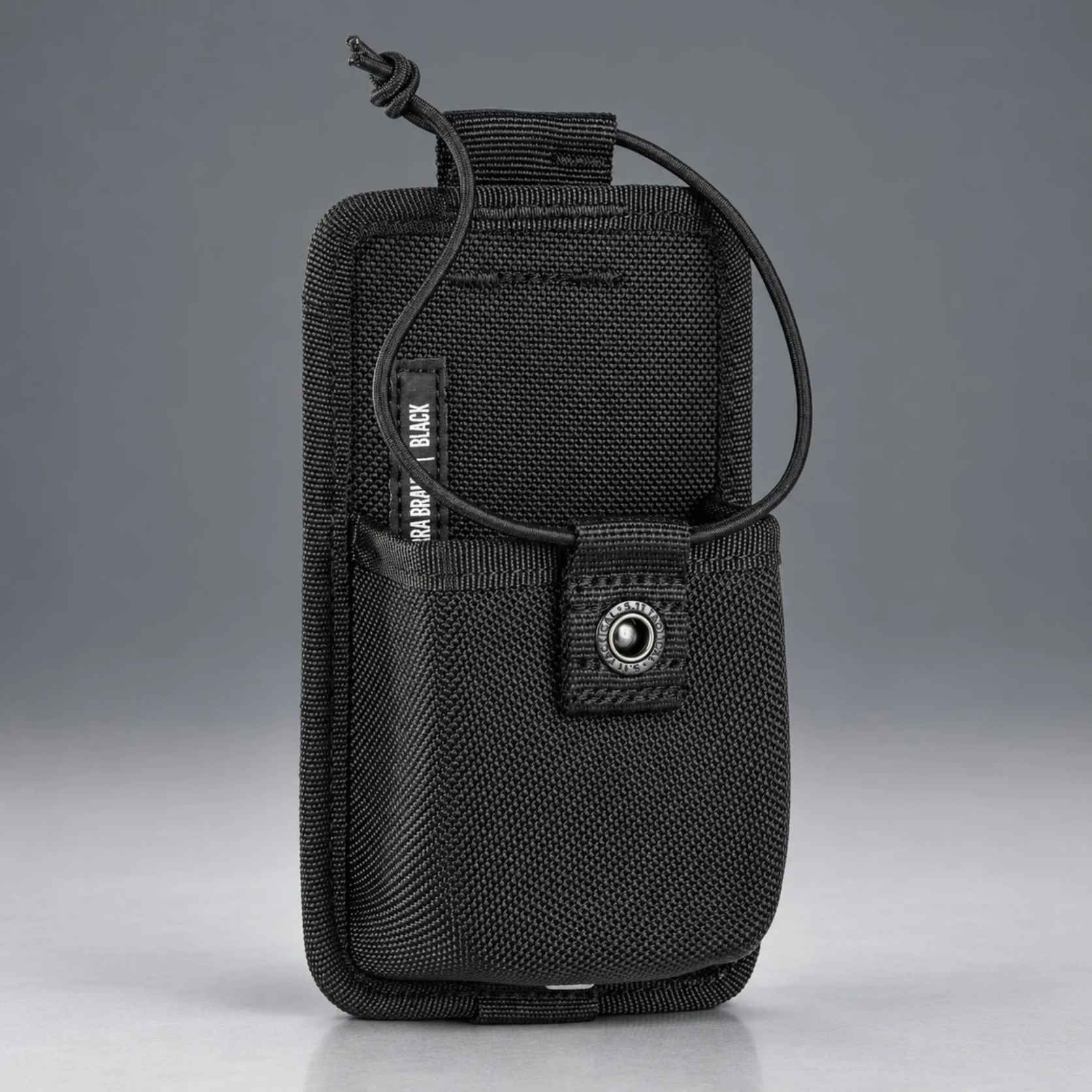 Angled front of the black 5.11 Sierra Bravo radio pouch showing 1680D nylon shell and snap tab