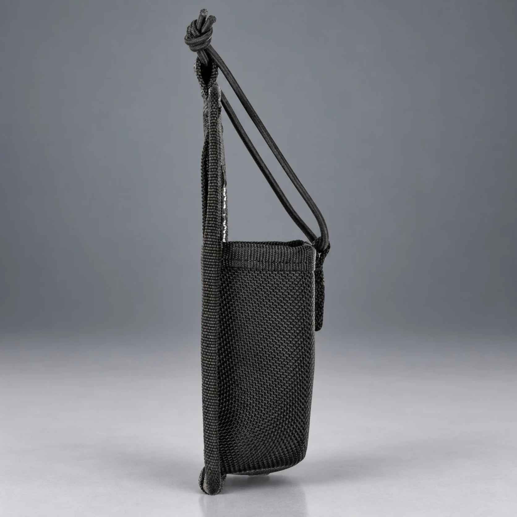 Left side profile of the 5.11 Sierra Bravo radio pouch with bungee cord and snap tab