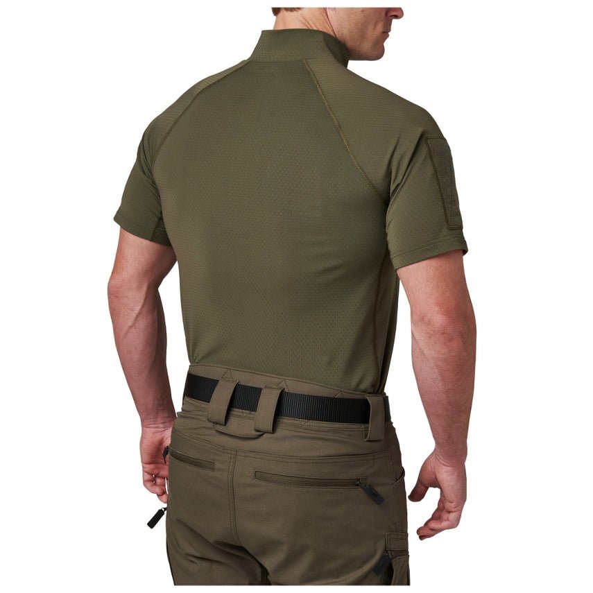 Person wearing an olive green tactical shirt and pants on a white background