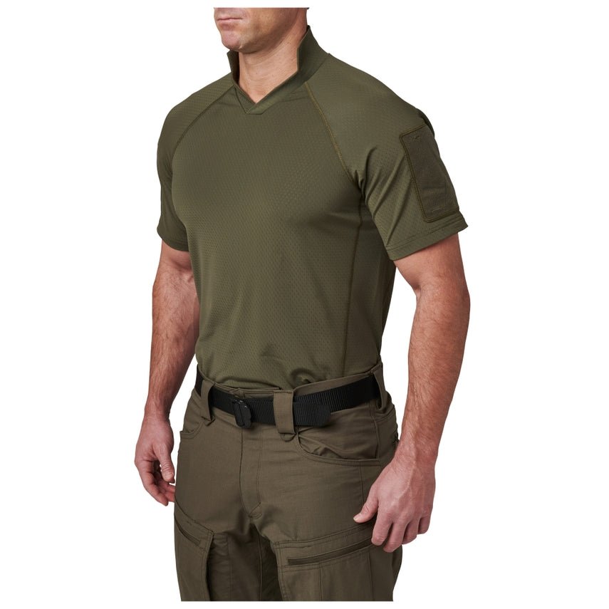 Person wearing an olive green tactical shirt and pants on a white background