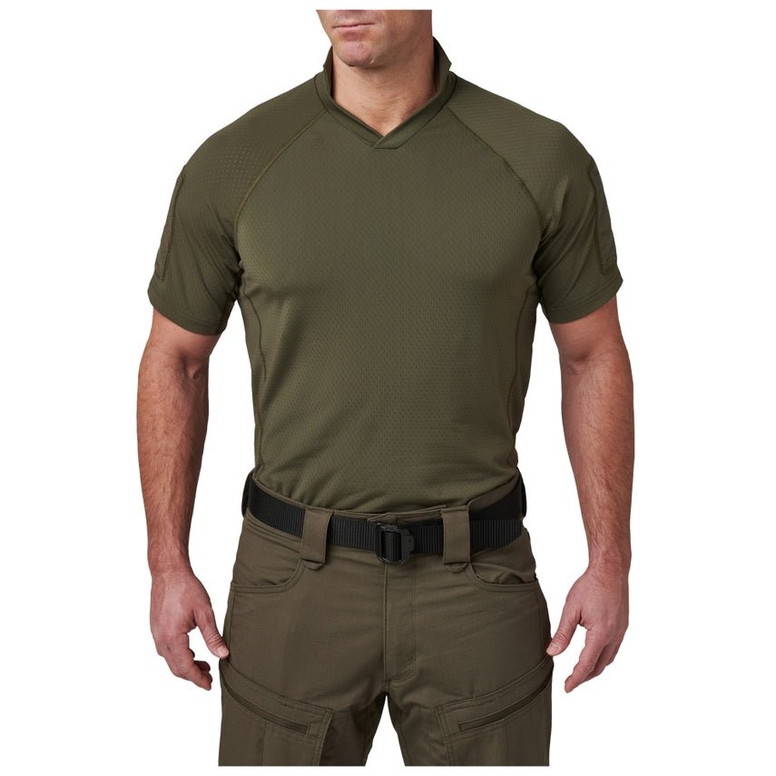 Person wearing an olive green short-sleeve shirt and pants on a white background