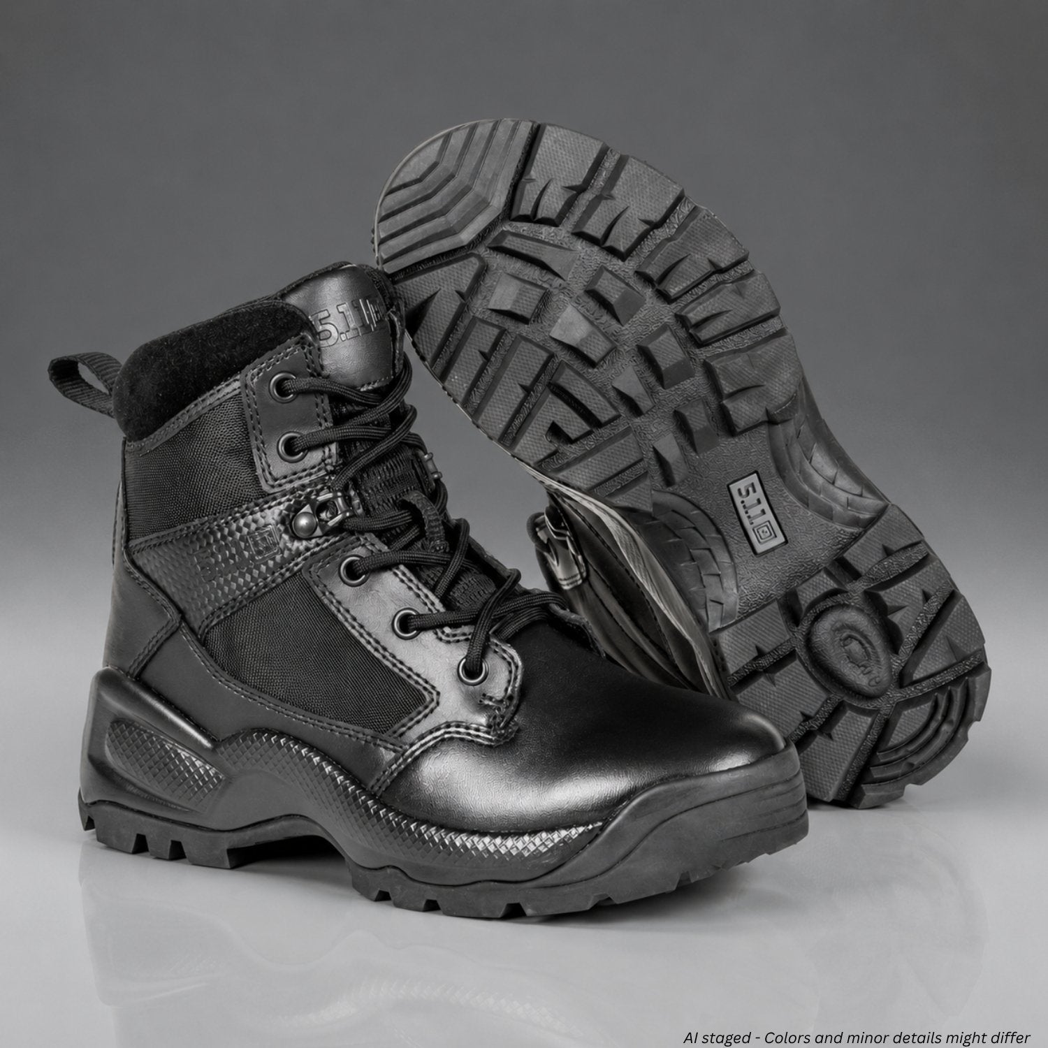 Black tactical boots with a focus on sole texture on a gray background