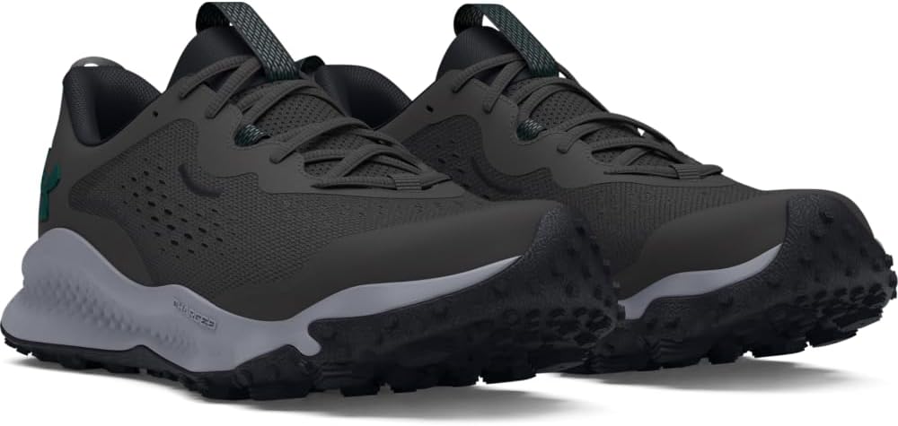 Pair of dark gray athletic shoes with black soles on a white background