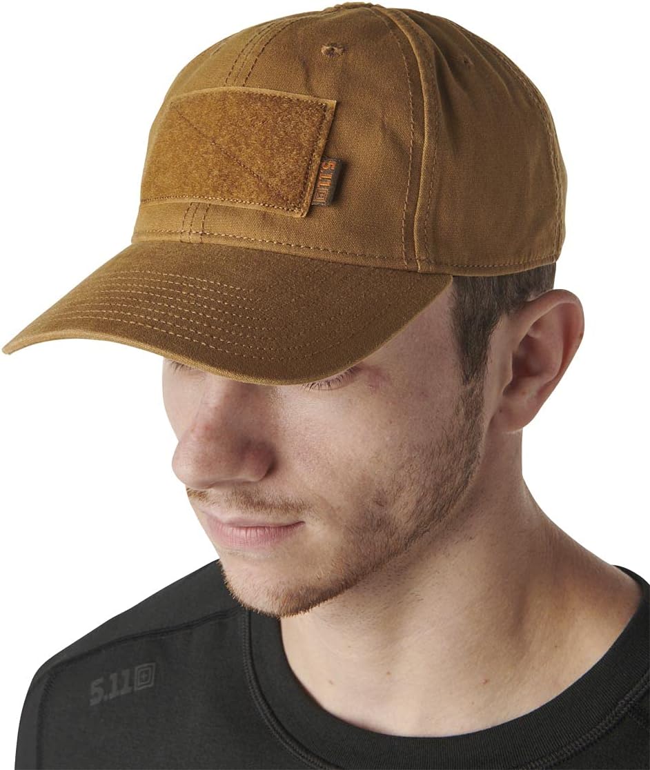 Man wearing a brown cap with a patch on a white background