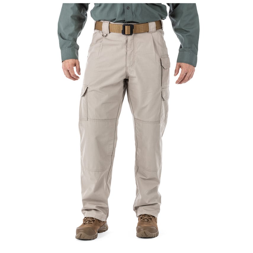 5.11 Tactical 100% Cotton Canvas Pants 74251 with cargo pockets, beige color, worn with tactical boots and belt.