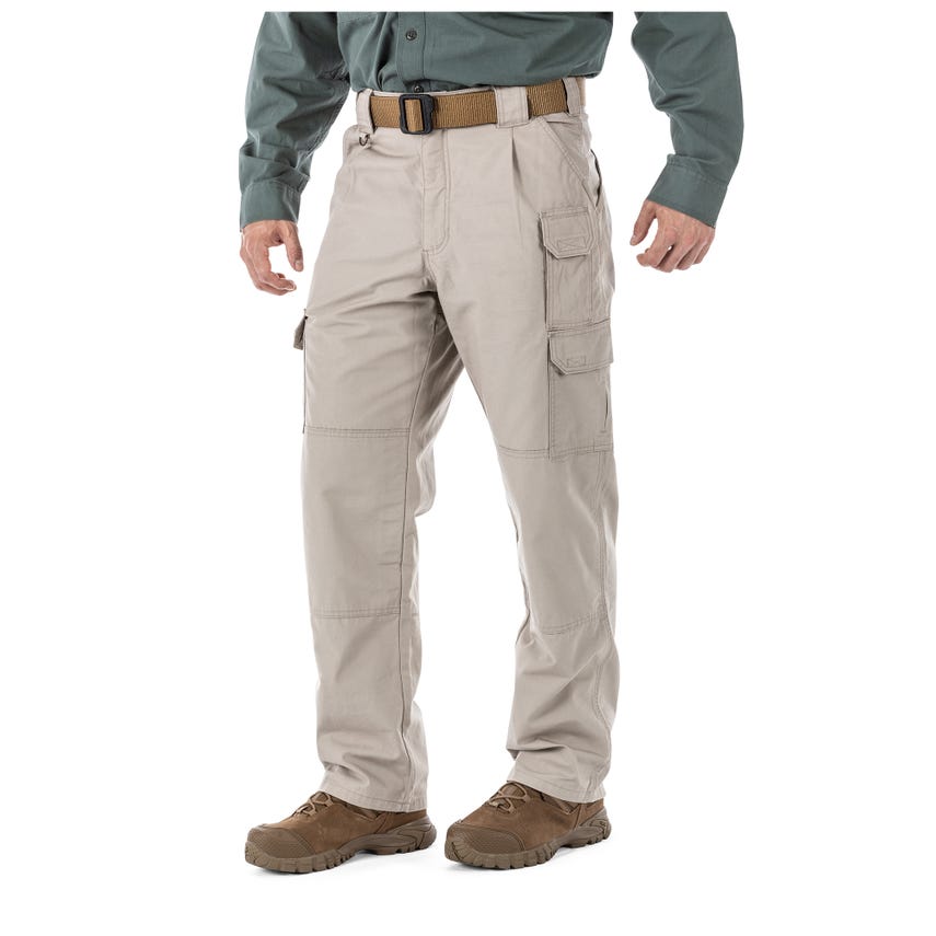 Man wearing 5.11 Tactical 100% Cotton Canvas Pants 74251, showcasing durability and comfort in a rugged environment.