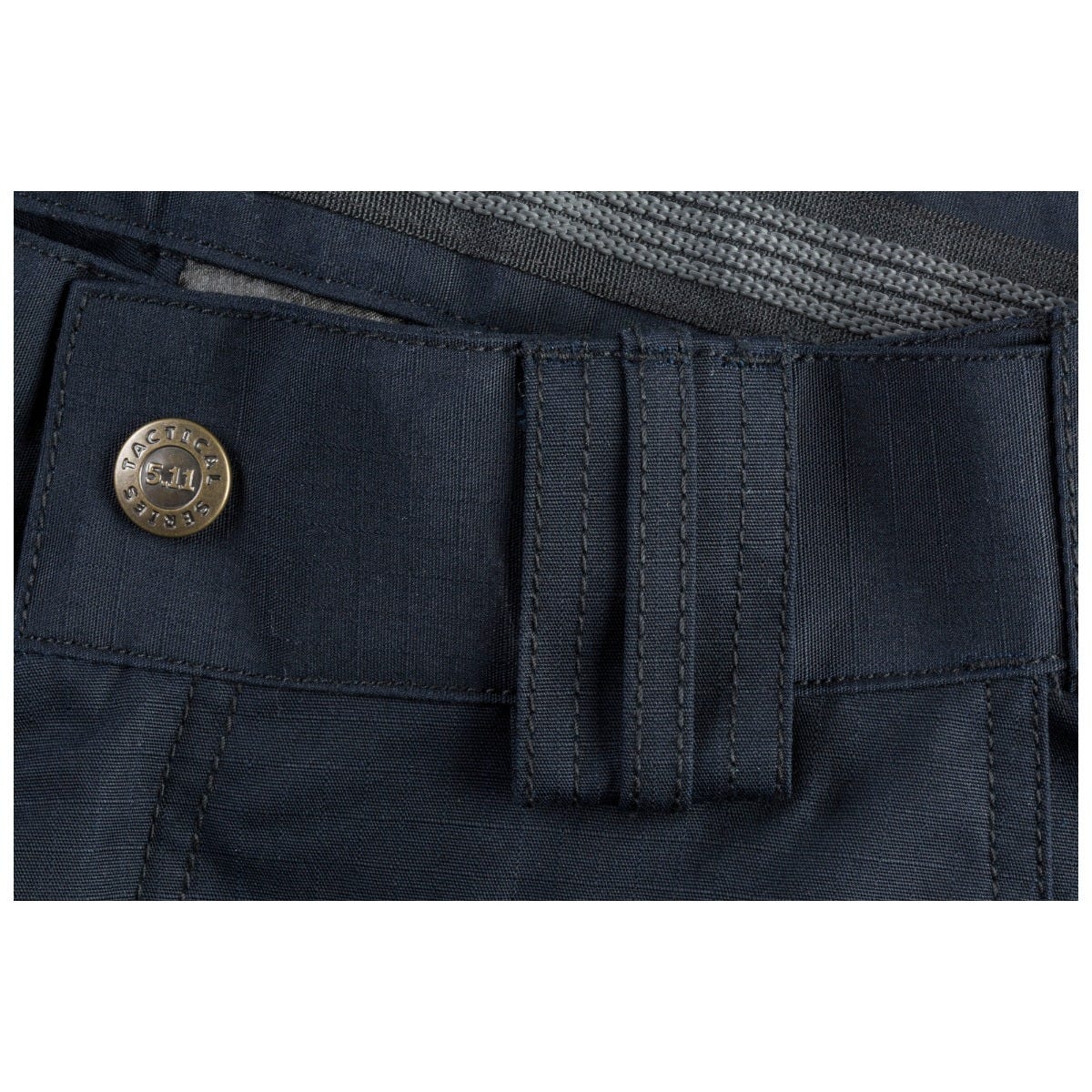 Close-up of a navy blue pocket with a button on a white background