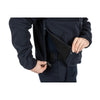 Person using the concealed pocket of the 5.11 Tactical Fleece 2.0 for secure storage in cold weather.