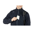 Man wearing 5.11 Tactical Fleece 2.0 jacket, retrieving a notepad from chest pocket, radio attached on shoulder.