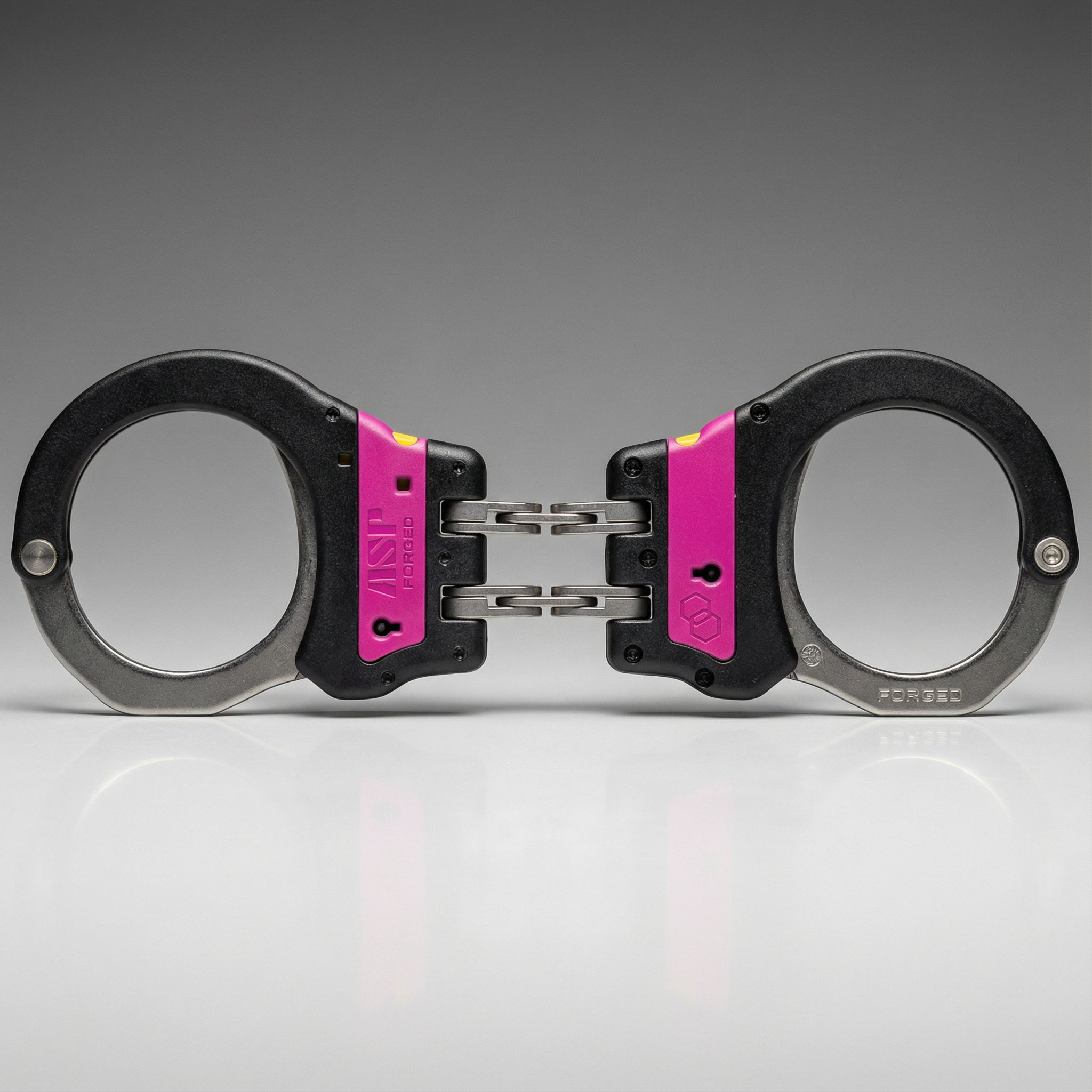 Handcuffs with pink accents on a gray background