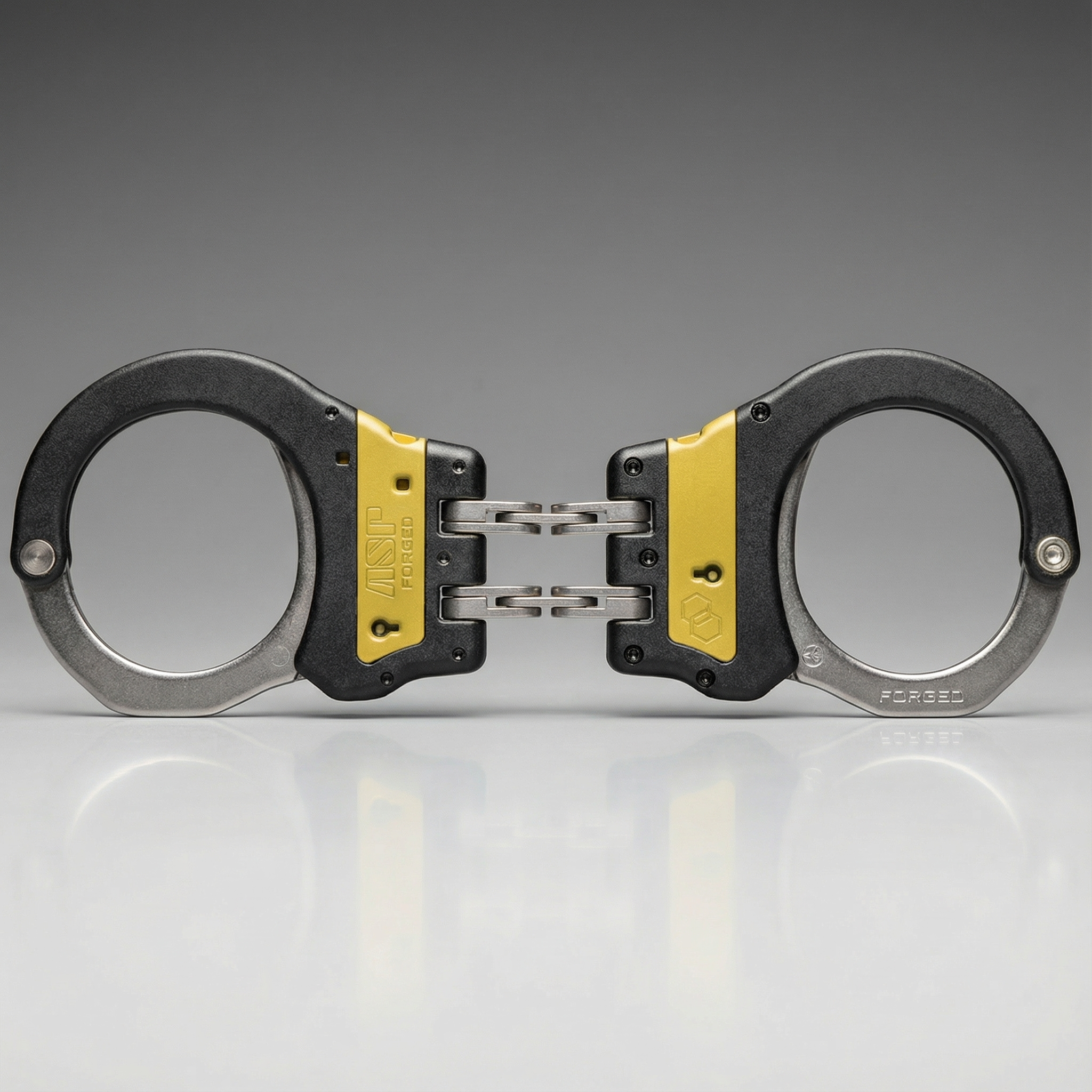 Pair of handcuffs with yellow accents on a gray background
