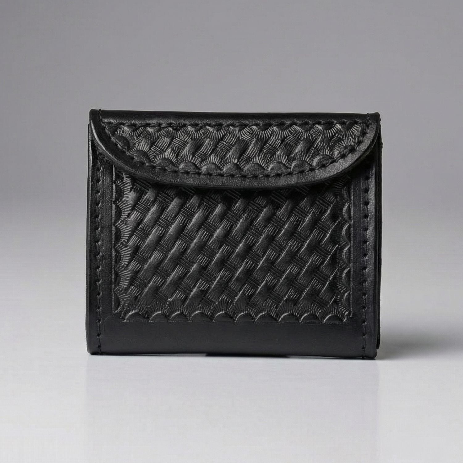 Black textured disposable glove holder on a gray background