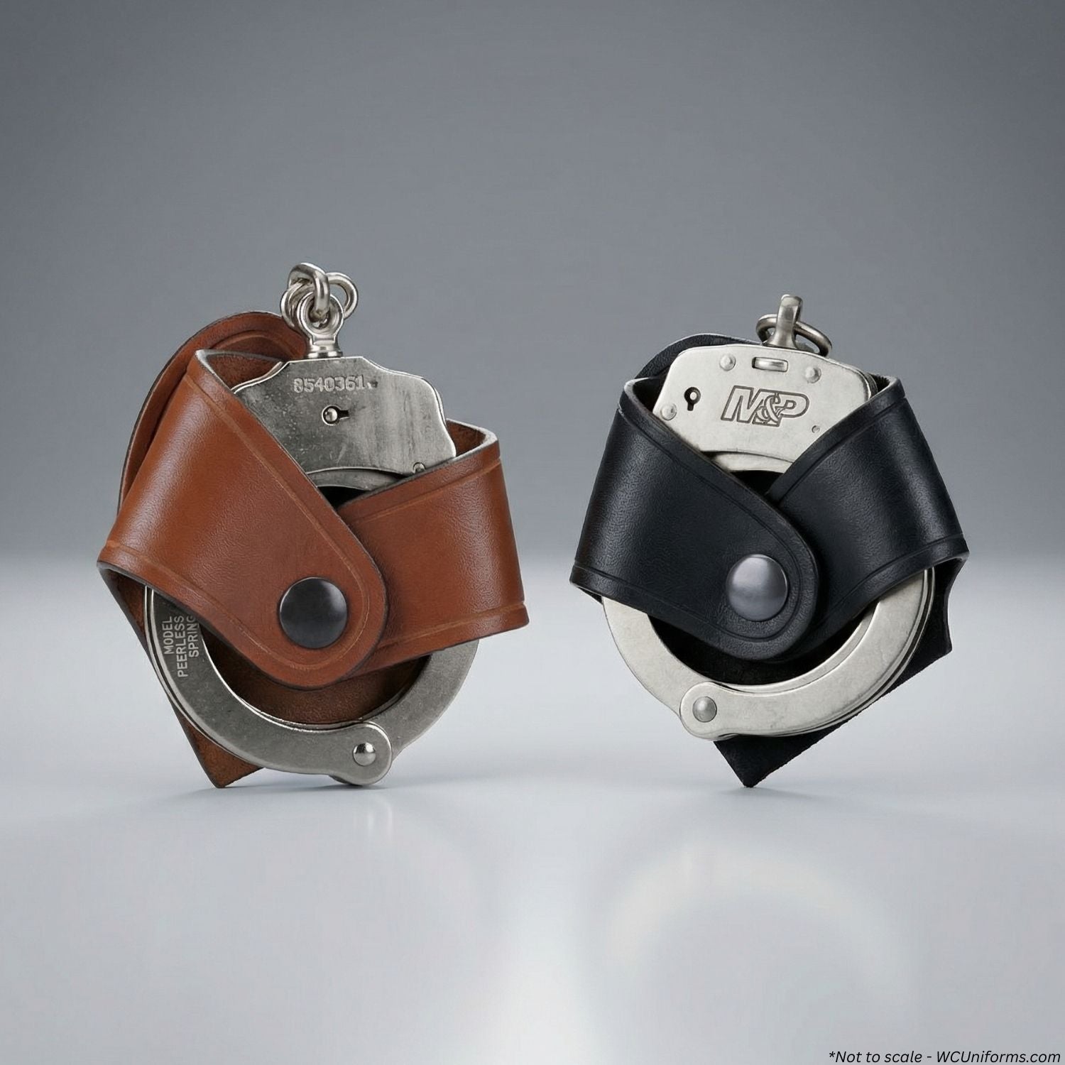 Two pairs of handcuffs in brown and black leather cases on a gray background