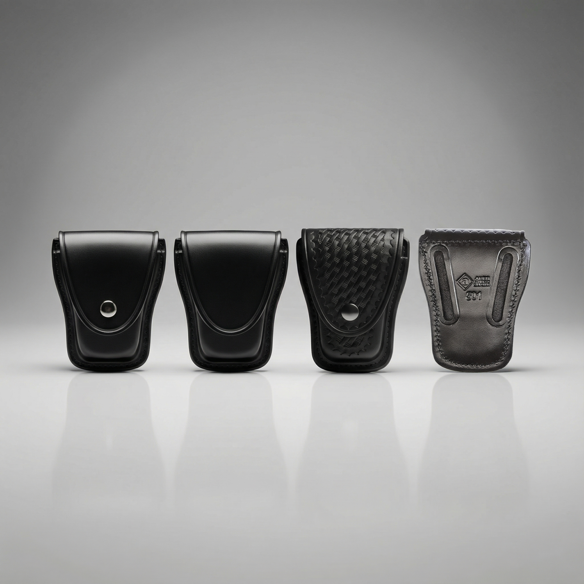 Four black leather pouches of different designs on a gray background