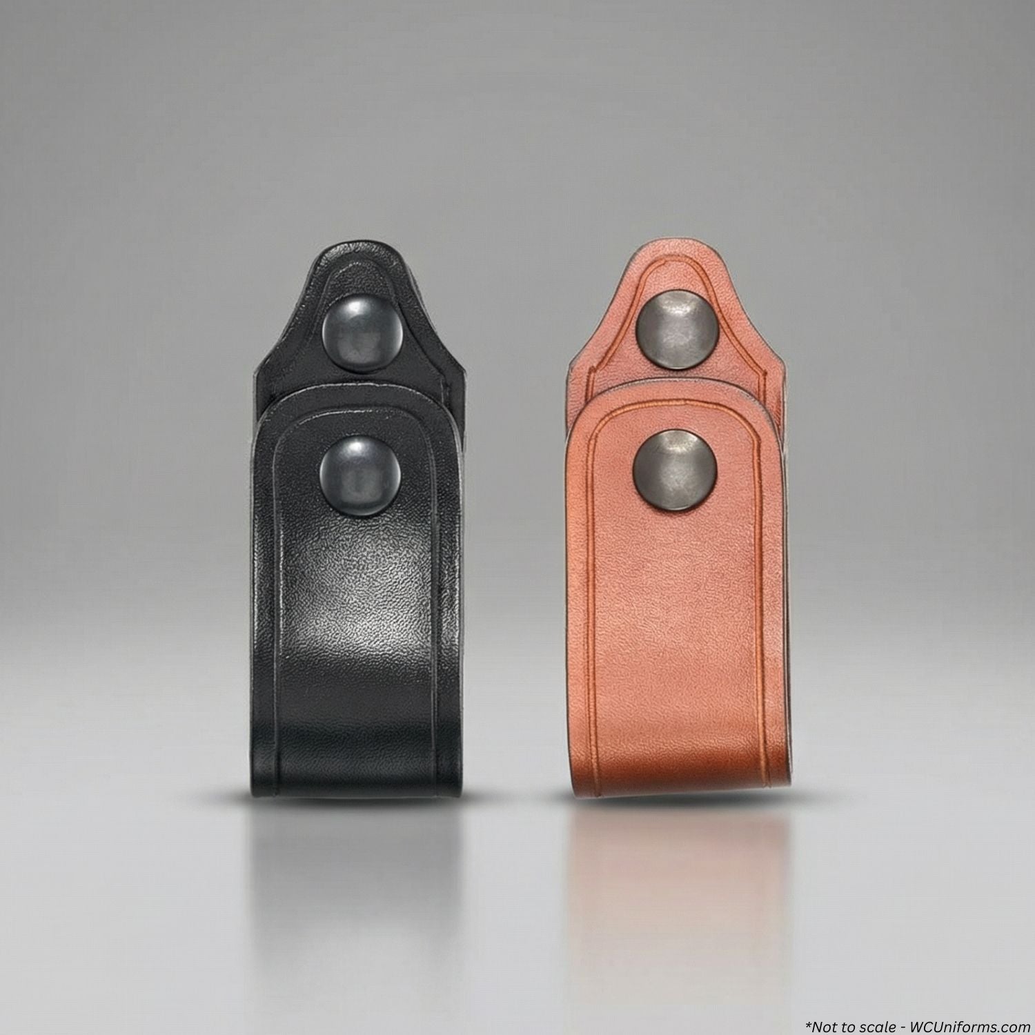 Black and brown leather holsters on a gray background