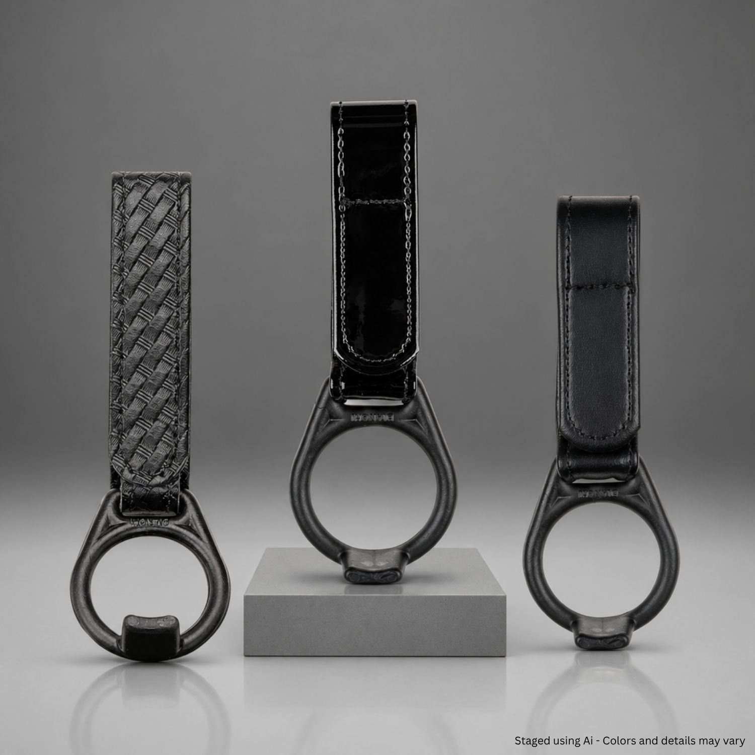 Three black faux leather PR-24 baton holders with different finishes on a gray background